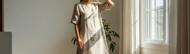 A women standing near window waering linen dress