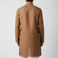 Man wearing a brown kurta against a white background