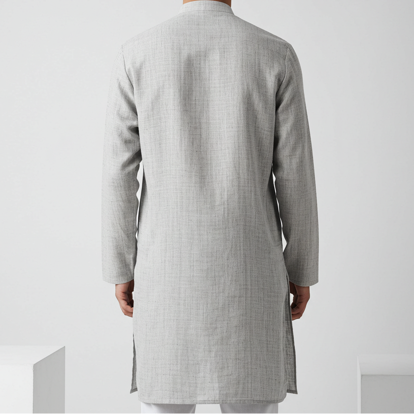 Man wearing a light gray kurta against a white background