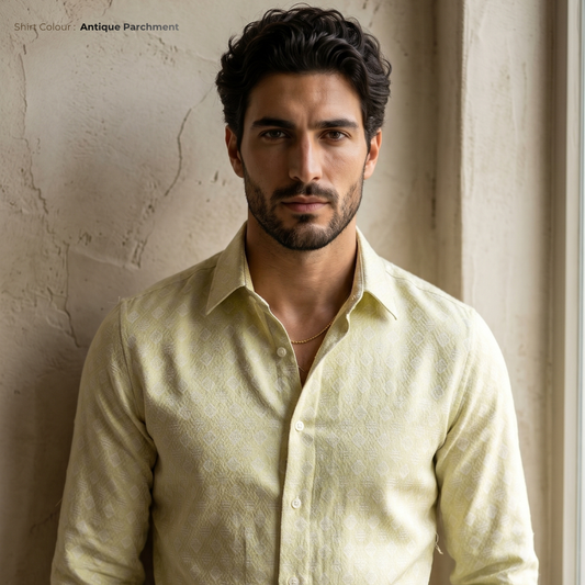 Man wearing a light-colored shirt against a textured wall