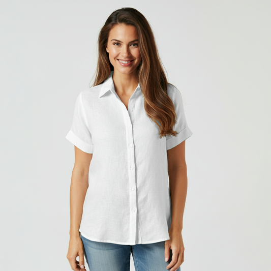 Woman wearing an OrganoLinen white short sleeve linen shirt and blue jeans.